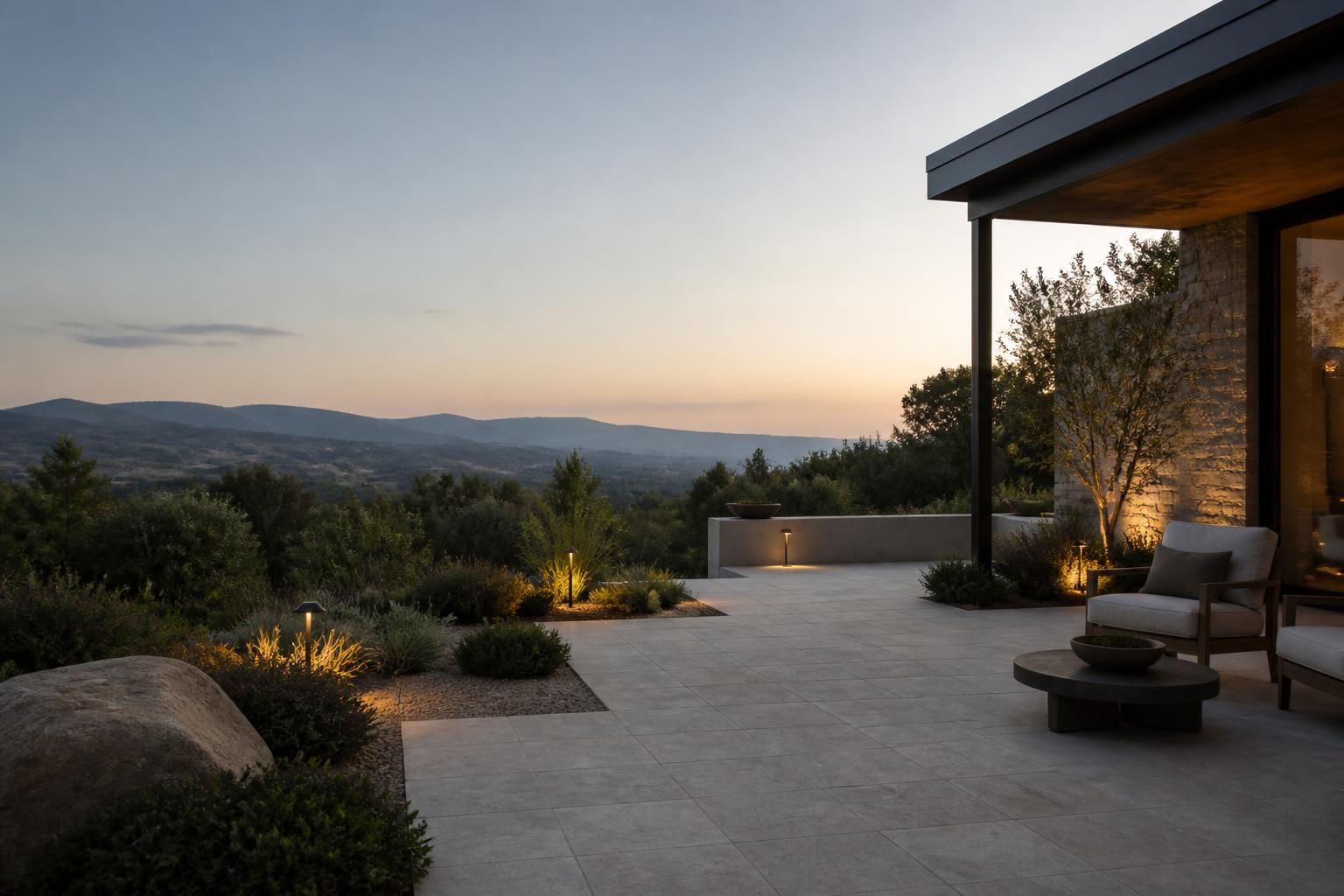 Serene outdoor retreat with patio and warm landscape lighting.